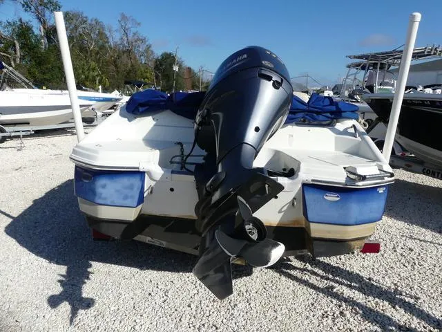 Slide: The Image of 2016 NauticStar 203 DC boat with outboard motor, parked on gravel lot. - 6