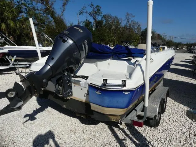 Slide: The Image of 2016 NauticStar 203 DC boat on trailer, blue and white, with outboard motor. - 7
