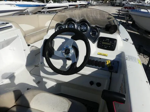 Slide: The Image of 2016 NauticStar 203 DC boat dashboard with steering wheel and control panel. - 8