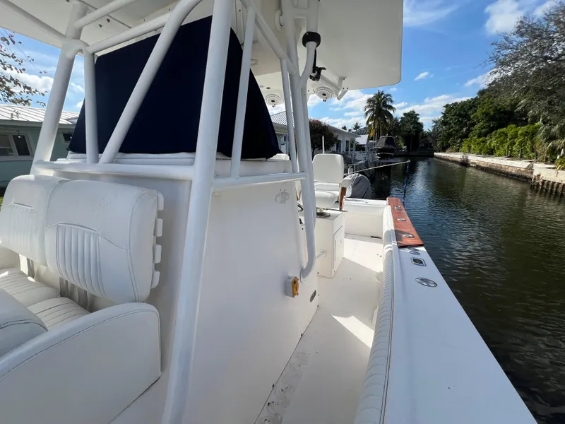 Slide: The Image of 2008 Regulator 32 FS boat on a canal, featuring white seating and clear skies. - 10
