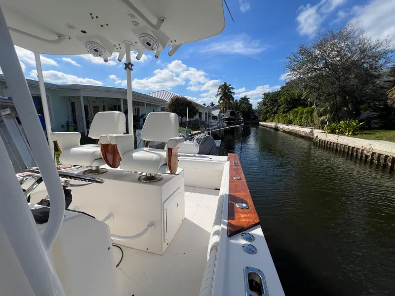 Slide: The Image of 2008 Regulator 32 FS boat docked in a scenic canal under a clear blue sky. - 11