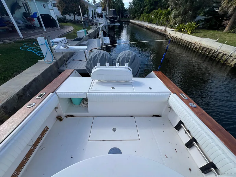 Slide: The Image of 2008 Regulator 32 FS boat docked in a canal, featuring spacious seating and dual engines. - 12