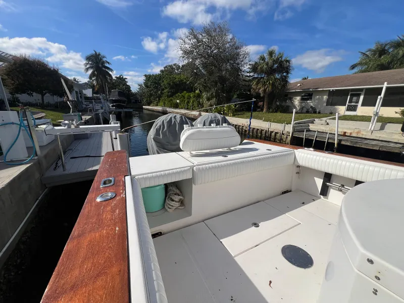 Slide: The Image of 2008 Regulator 32 FS boat docked in a sunny canal setting. - 14