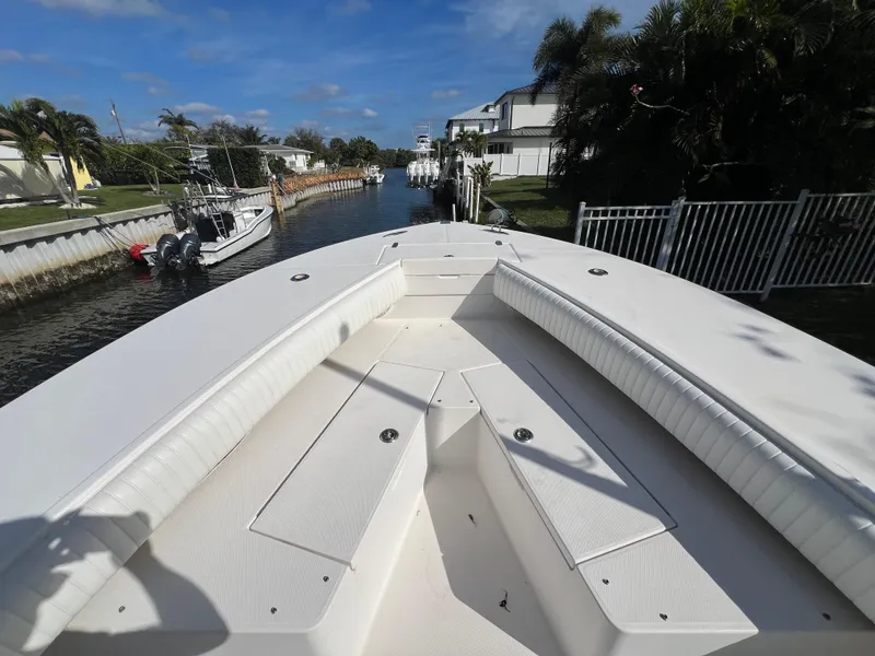 Slide: The Image of 2008 Regulator 32 FS boat docked in a sunny residential canal. - 19