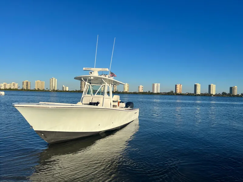 Slide: The Image of 2008 Regulator 32 FS boat on calm water with city skyline in background. - 3
