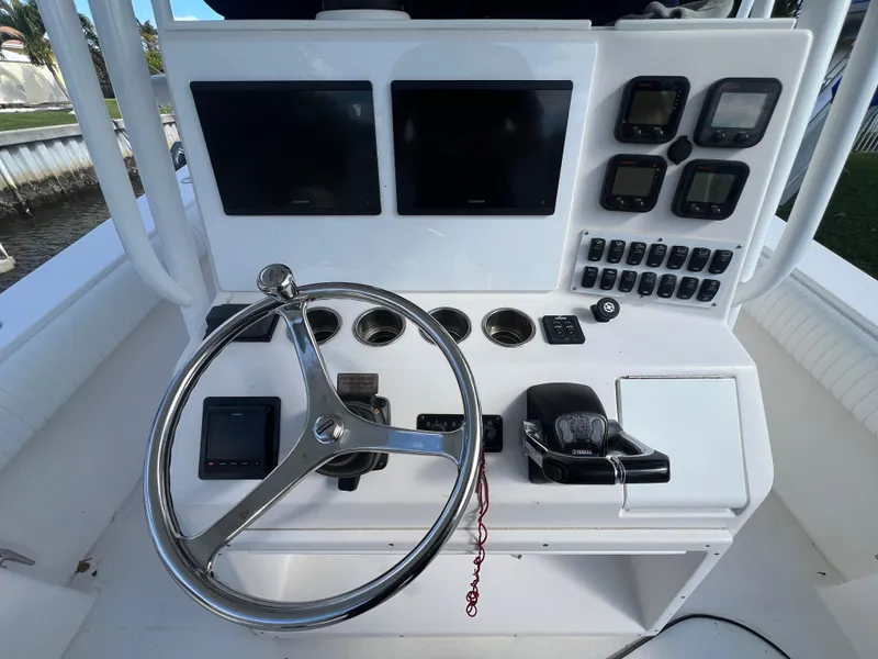 Slide: The Image of 2008 Regulator 32 FS boat dashboard with steering wheel and electronic controls. - 5
