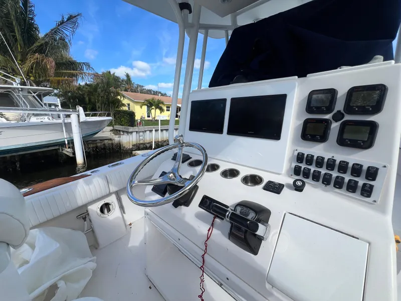Slide: The Image of 2008 Regulator 32 FS boat cockpit with steering wheel and control panels. - 6