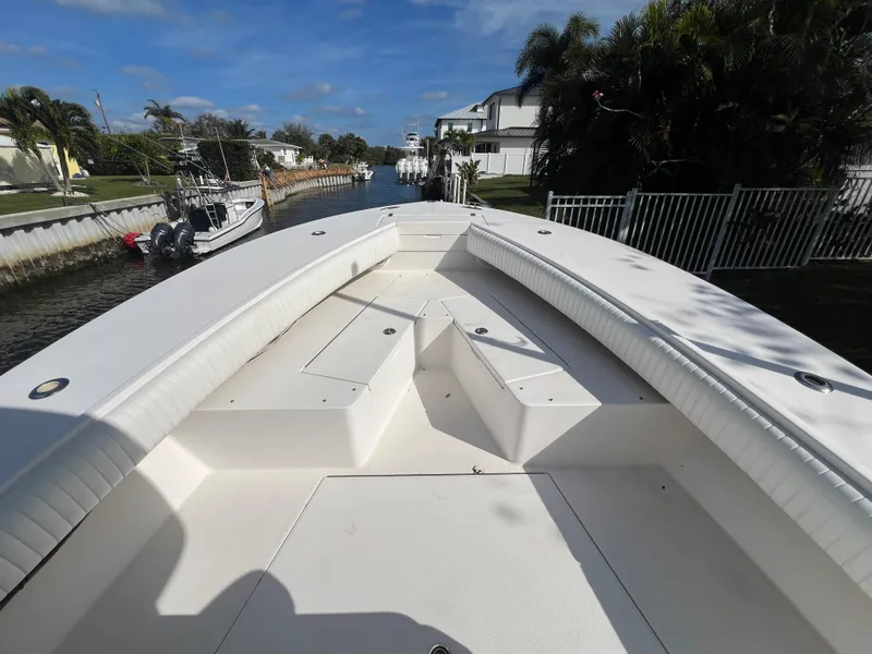 Slide: The Image of 2008 Regulator 32 FS boat bow view in a sunny canal setting. - 9