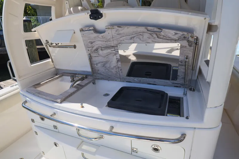 Slide: The Image of 2021 Solace 345 boat kitchen area with sink and storage compartments. - 10