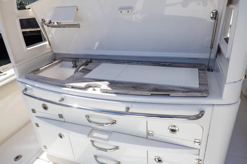Slide: The Image of Outdoor kitchen setup on a 2021 Solace 345 boat, featuring storage drawers and a countertop. - 13