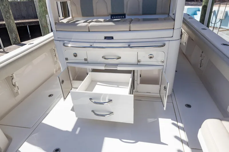 Slide: The Image of 2021 Solace 345 boat interior with open storage drawers and seating area. - 15