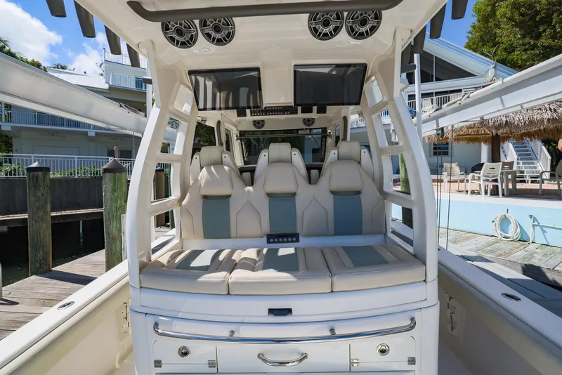 Slide: The Image of Luxury seating on a 2021 Solace 345 boat docked at a marina. - 16