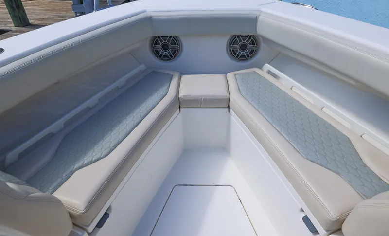 Slide: The Image of 2021 Solace 345 boat interior with cushioned seating and speakers. - 2
