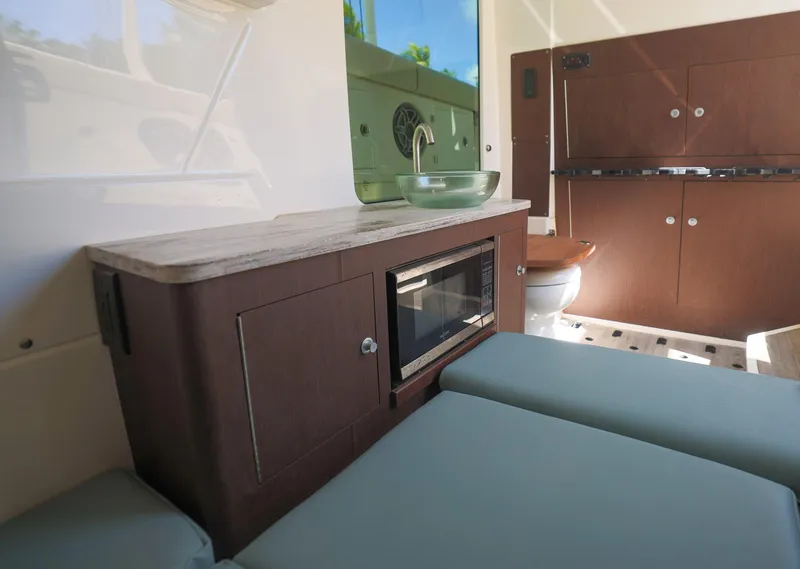 Slide: The Image of Interior of 2021 Solace 345 boat with kitchenette and seating area. - 22