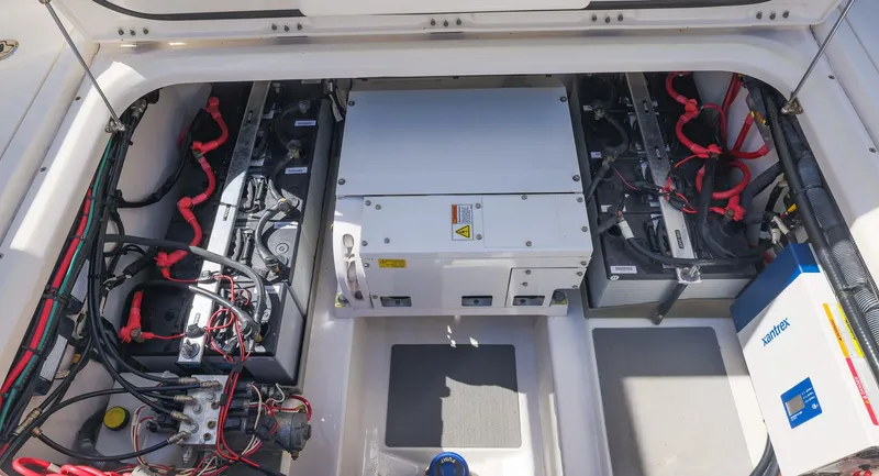 Slide: The Image of Engine compartment of 2021 Solace 345 boat, showcasing battery setup and wiring. - 27