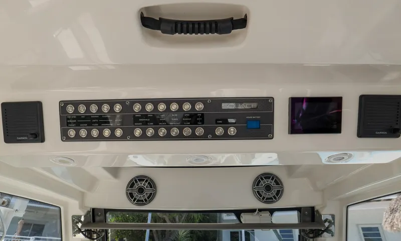 Slide: The Image of Control panel of a 2021 Solace 345 boat with switches and speakers. - 35