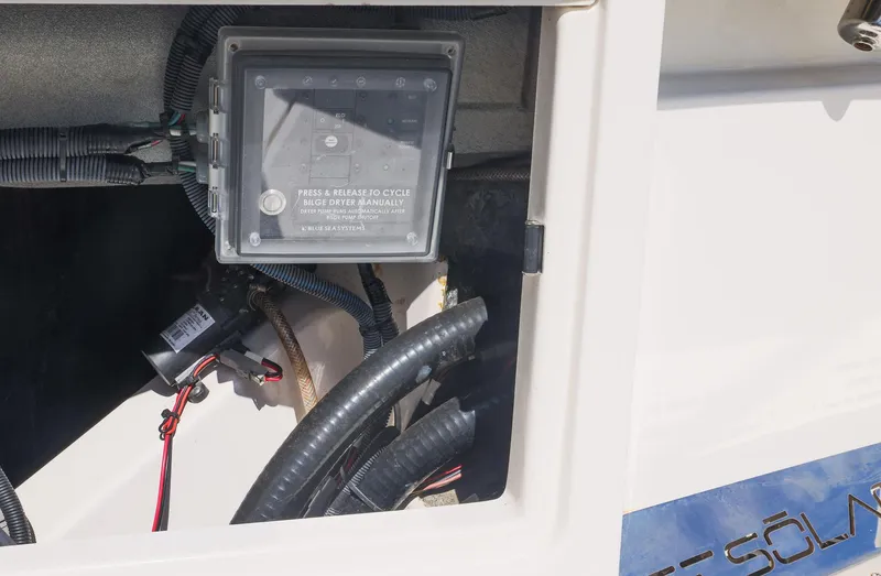 Slide: The Image of Electrical compartment of a 2021 Solace 345 boat, featuring wiring and control box. - 42