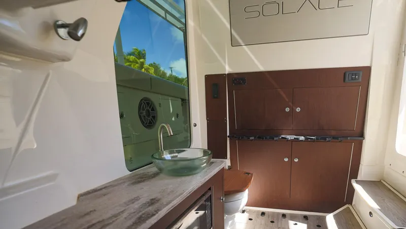 Slide: The Image of Interior of 2021 Solace 345 boat with modern sink and cabinetry. - 46
