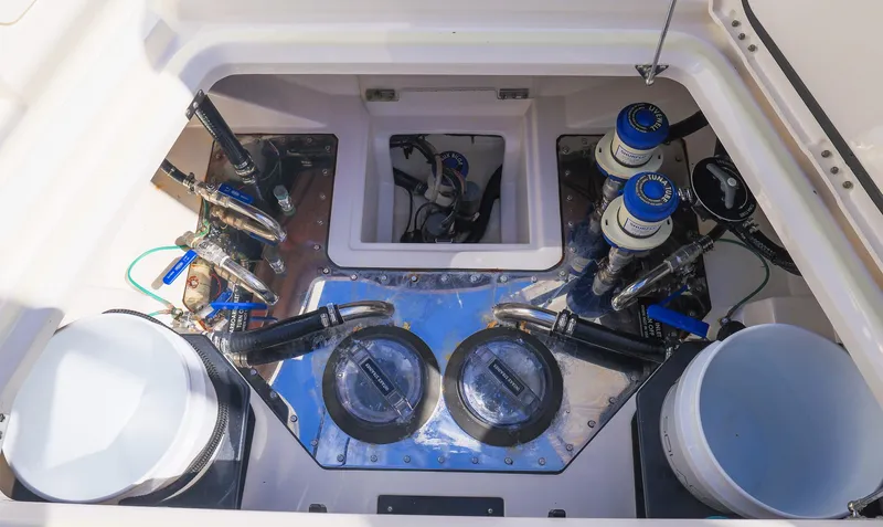 Slide: The Image of Engine compartment of 2021 Solace 345 boat, showcasing mechanical components and wiring. - 48