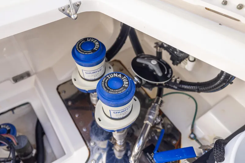 Slide: The Image of Boat plumbing system in a 2021 Solace 345 model, featuring Shurflo livewell and tuna tube components. - 49