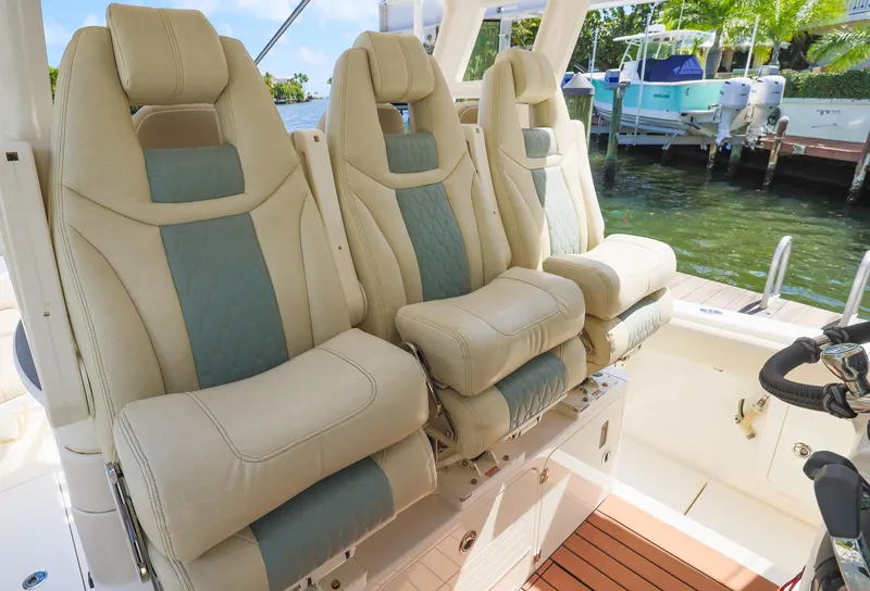 Slide: The Image of Luxurious seating on 2021 Solace 345 boat, featuring plush, ergonomic design near a serene waterfront. - 6