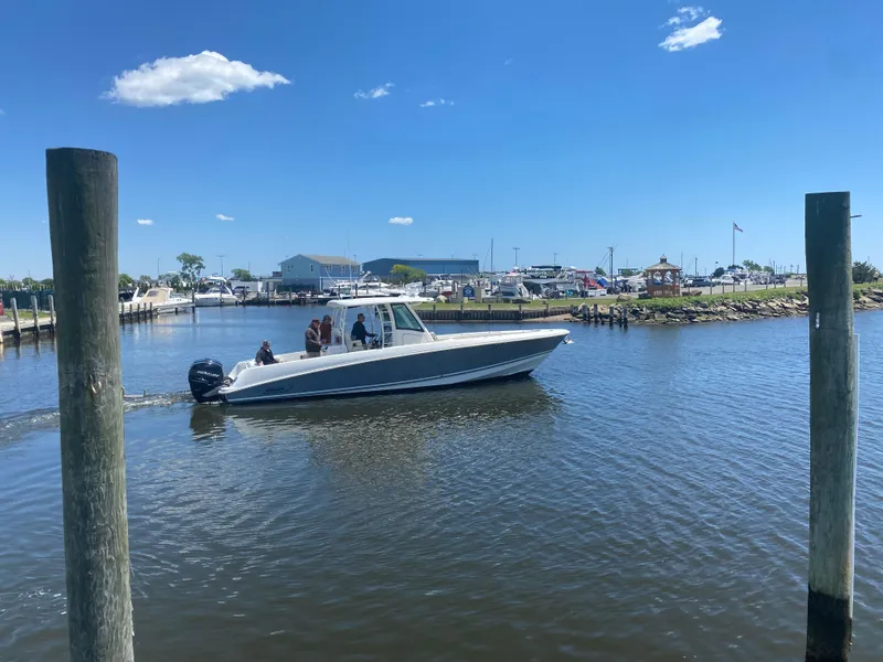 Slide: The Image of 2017 Boston Whaler 350 Outrage cruising on a sunny day in a marina. - 1
