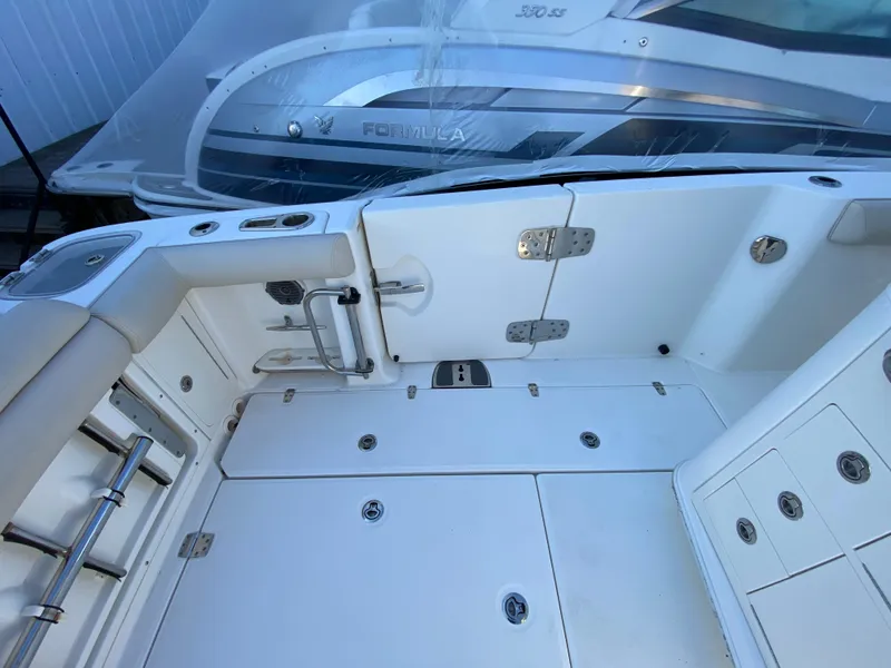 Slide: The Image of 2017 Boston Whaler 350 Outrage boat deck, featuring storage compartments and seating area. - 14