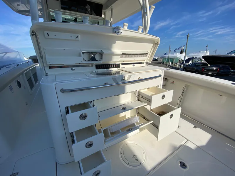 Slide: The Image of 2017 Boston Whaler 350 Outrage boat interior with open storage compartments. - 16