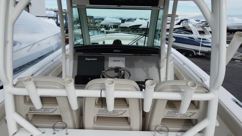 Slide: The Image of 2017 Boston Whaler 350 Outrage boat interior with helm and seating. - 19