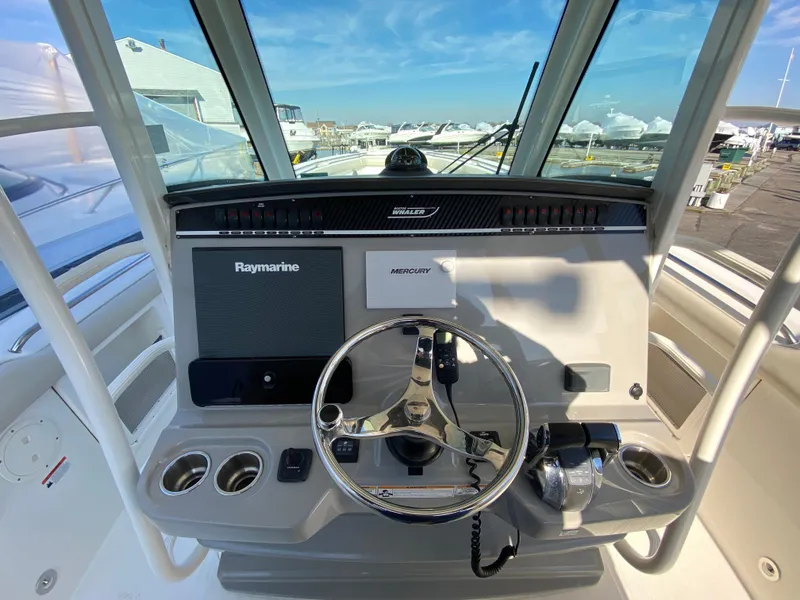 Slide: The Image of 2017 Boston Whaler 350 Outrage helm with Raymarine electronics and Mercury controls. - 20