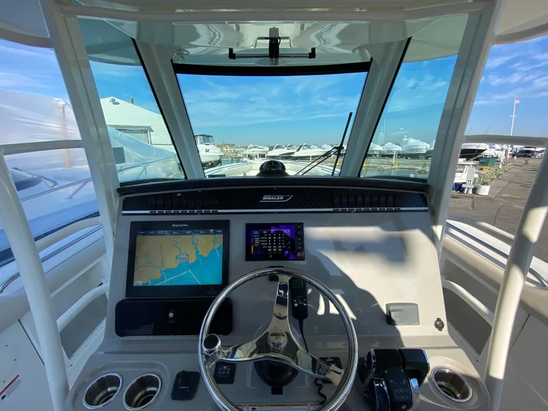 Slide: The Image of 2017 Boston Whaler 350 Outrage helm with navigation screens and steering wheel. - 21