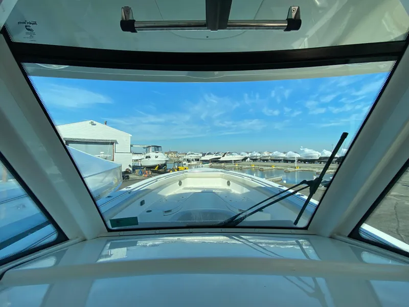 Slide: The Image of 2017 Boston Whaler 350 Outrage boat view from cockpit, marina background. - 22