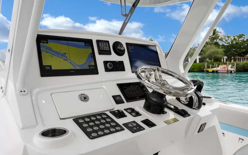 Slide: The Image of 2020 Intrepid 407 Panacea helm with navigation screens and steering wheel. - 13