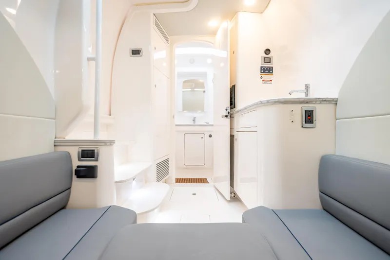 Slide: The Image of Interior of 2020 Intrepid 407 Panacea boat, featuring modern seating and compact kitchenette. - 20