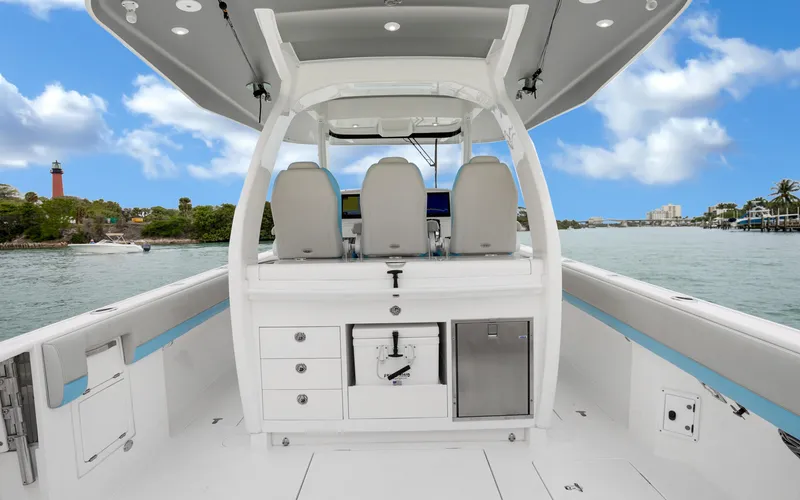 Slide: The Image of 2020 Intrepid 407 Panacea boat interior with seating and storage, on a scenic waterway. - 24