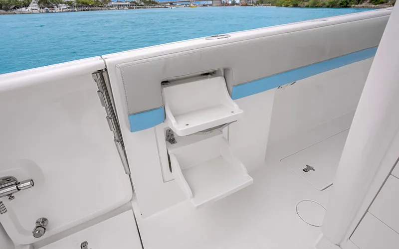Slide: The Image of 2020 Intrepid 407 Panacea boat with fold-out steps by the water. - 28