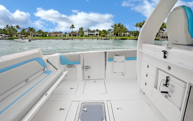 Slide: The Image of 2020 Intrepid 407 Panacea boat interior with seating, storage, and scenic waterfront view. - 30