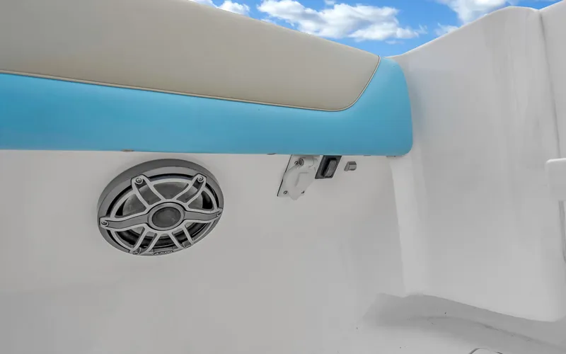 Slide: The Image of 2020 Intrepid 407 Panacea boat interior with speaker and blue trim under a clear sky. - 32