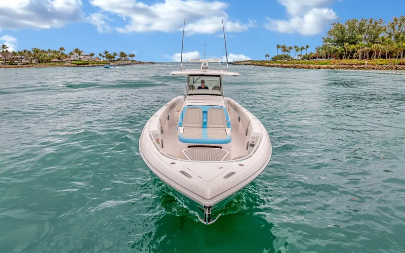 Slide: The Image of 2020 Intrepid 407 Panacea boat cruising on clear water under a blue sky. - 4