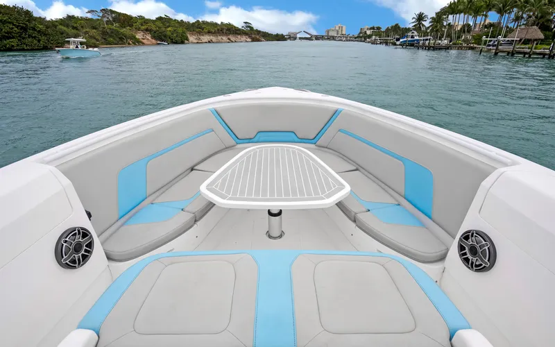Slide: The Image of 2020 Intrepid 407 Panacea boat interior with seating and table on calm water. - 7