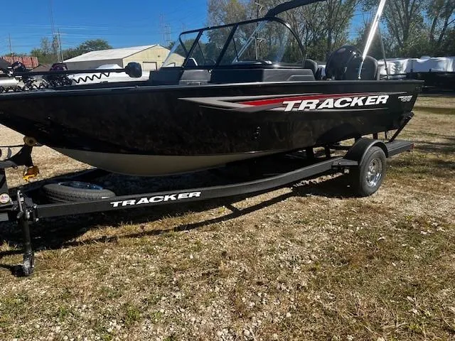 Slide: The Image of 2025 Tracker Pro Guide V-175 Combo boat on trailer, parked outdoors. - 2