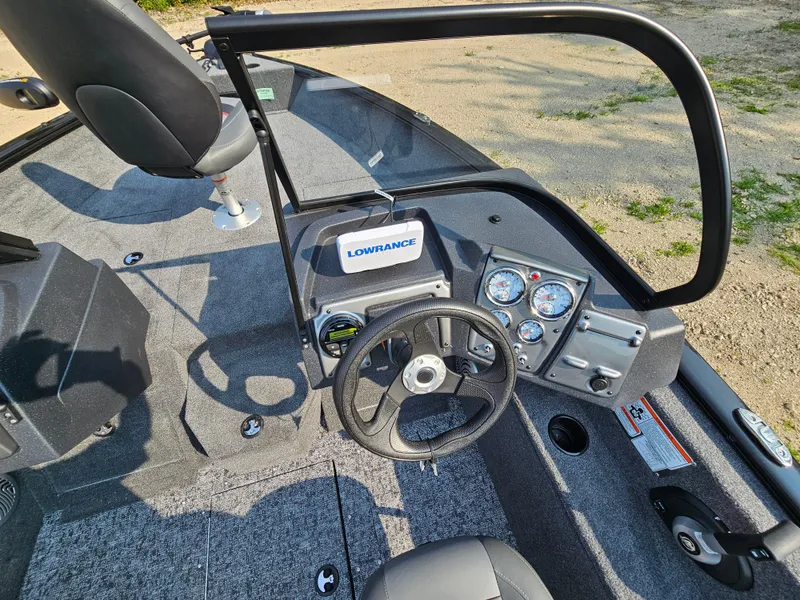 Slide: The Image of 2025 Tracker Pro Guide V-175 Combo boat dashboard with steering wheel and gauges. - 3