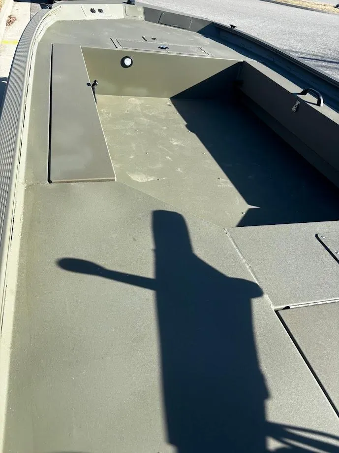 Slide: The Image of 2025 Tracker Grizzly 1654 T Sportsman boat interior, showcasing spacious deck and seating area. - 2