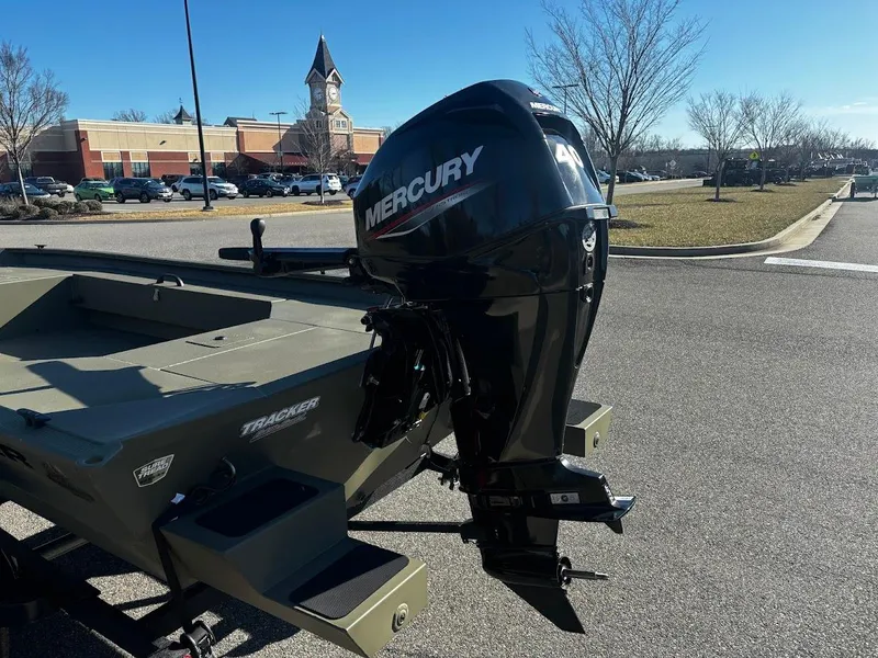 Slide: The Image of 2025 Tracker Grizzly 1654 T Sportsman boat with Mercury outboard motor in parking lot. - 4