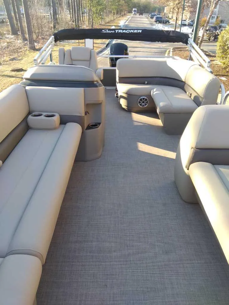 Slide: The Image of 2025 Sun Tracker Party Barge 18 DLX with spacious seating and modern design. - 2