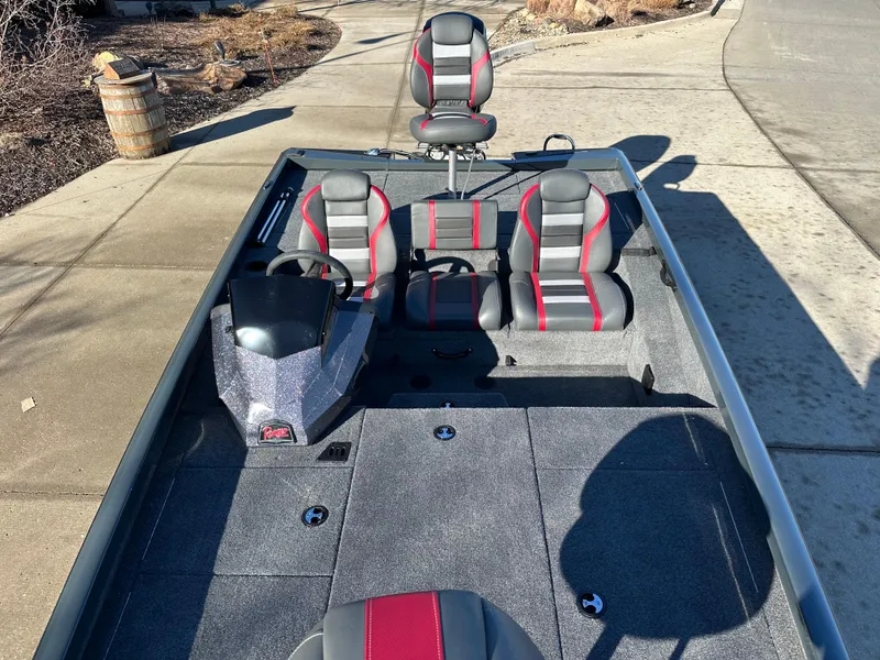Slide: The Image of 2025 Ranger RT188P boat with gray and red seating, parked on a concrete driveway. - 6