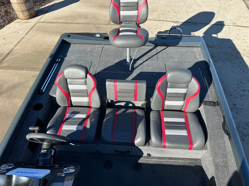 Slide: The Image of 2025 Ranger RT188P boat interior with gray and red seats, steering wheel, and carpeted flooring. - 7