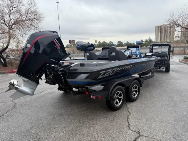 Slide: The Image of 2025 Nitro Z20 XL Pro boat on trailer, parked outdoors, showcasing sleek design and powerful engine. - 8