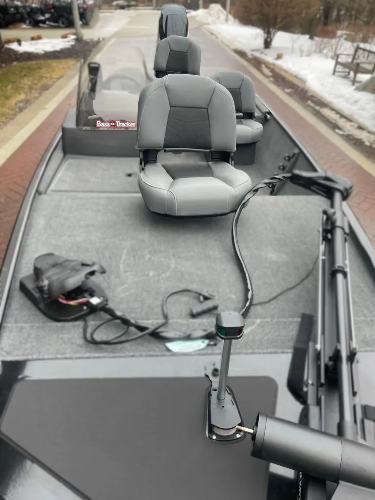 Slide: The Image of 2025 Tracker Bass Tracker Classic XL boat with gray seating and fishing equipment. - 3