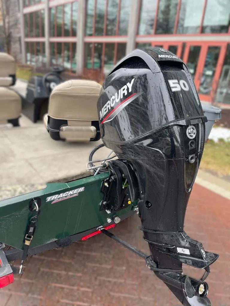 Slide: The Image of 2025 Tracker Bass Tracker Classic Limited with Mercury 50 outboard motor, parked outdoors. - 4
